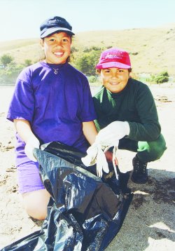 Doni Ranginui and Kylie Johnston, of Linwood North School, wave goodbye to rubbish at Taylor's Mistake