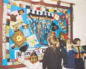 Children handle the many textures of the Manuka
Cottage banner just after it was unveiled