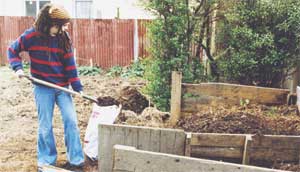 A volunteer at the Strickland Street garden bags
compost