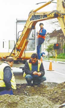 Workers get down to the nitty gritty of fixing this pot hole on Rolleston Avenue