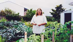 Sue Wilkinson checks progress in the flourishing Linwood community garden. 