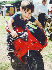 Look Mum, just the right size! A small boy enjoys last year�s Sport �n Action.