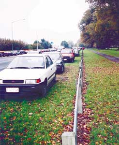 illegaly parked cars on a grass verge
